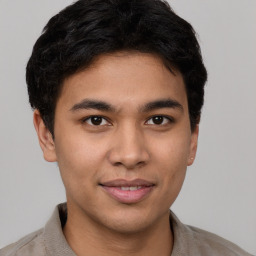 Joyful latino young-adult male with short  brown hair and brown eyes