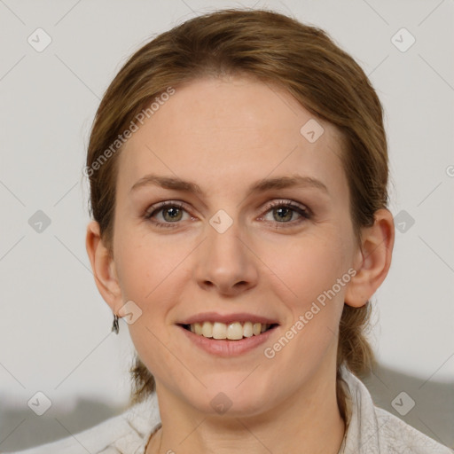 Joyful white young-adult female with medium  brown hair and grey eyes