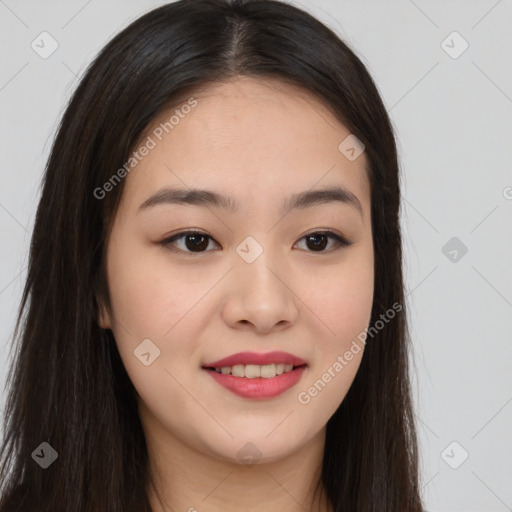 Joyful asian young-adult female with long  brown hair and brown eyes