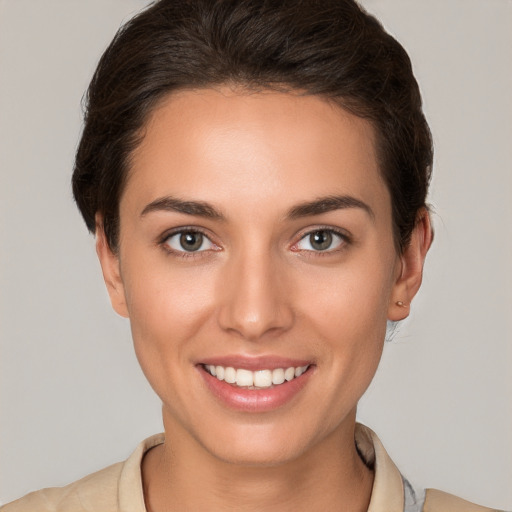 Joyful white young-adult female with short  brown hair and brown eyes