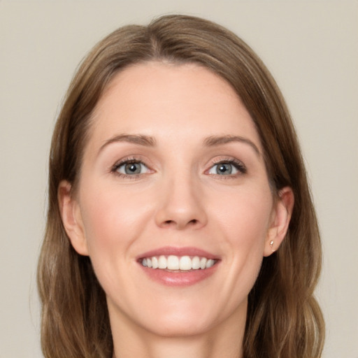 Joyful white young-adult female with long  brown hair and blue eyes