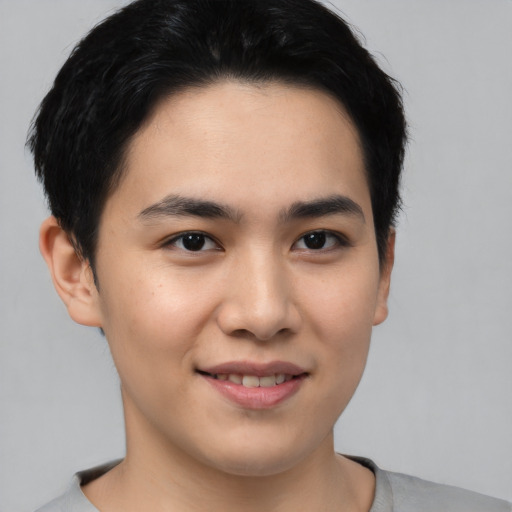 Joyful asian young-adult male with short  brown hair and brown eyes