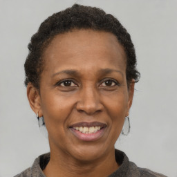 Joyful black adult female with short  brown hair and brown eyes