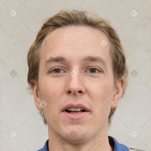 Joyful white adult male with short  brown hair and grey eyes