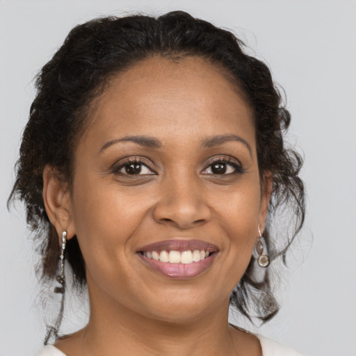 Joyful black young-adult female with medium  brown hair and brown eyes