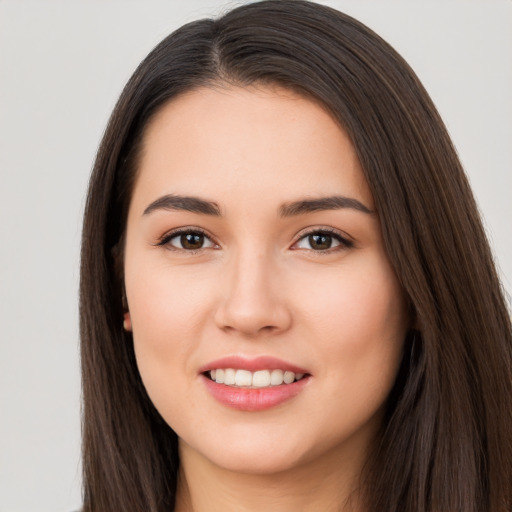 Joyful white young-adult female with long  brown hair and brown eyes