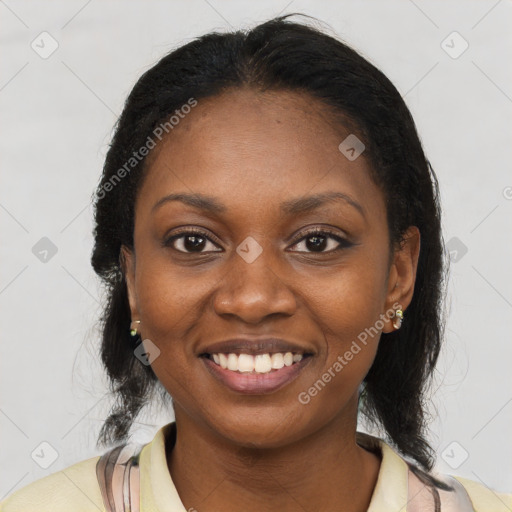 Joyful black young-adult female with long  black hair and brown eyes