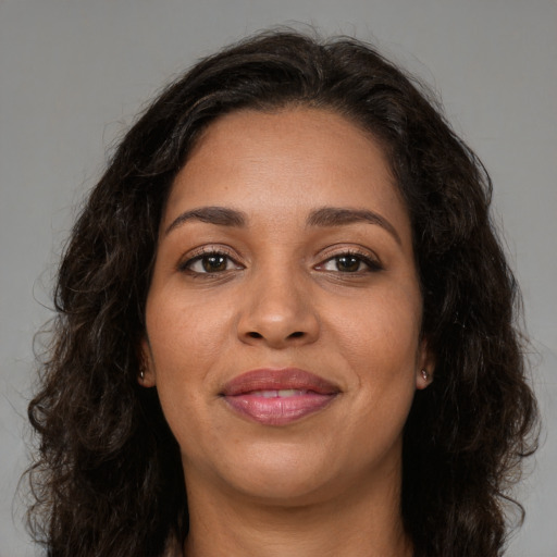 Joyful latino young-adult female with long  brown hair and brown eyes