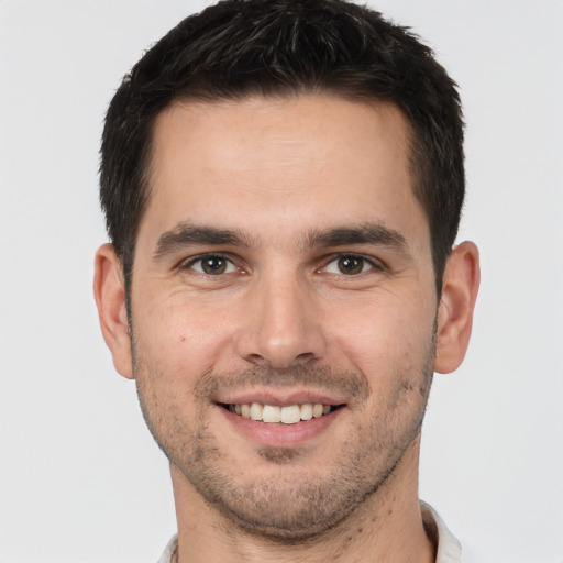 Joyful white young-adult male with short  brown hair and brown eyes