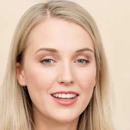 Joyful white young-adult female with long  brown hair and blue eyes