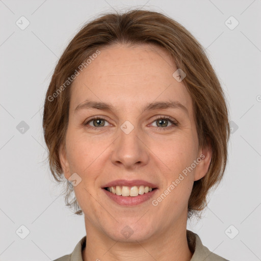 Joyful white adult female with medium  brown hair and grey eyes