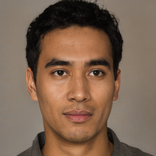 Joyful asian young-adult male with short  black hair and brown eyes