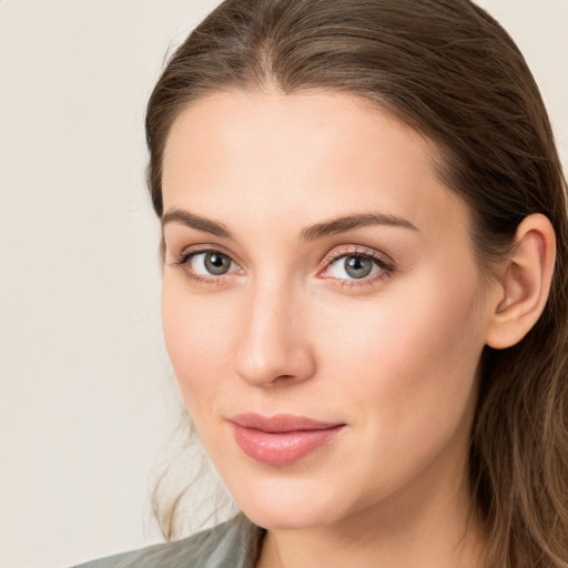 Joyful white young-adult female with long  brown hair and green eyes