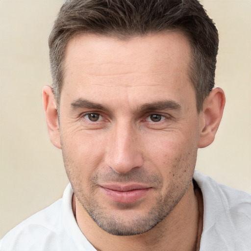 Joyful white adult male with short  brown hair and brown eyes