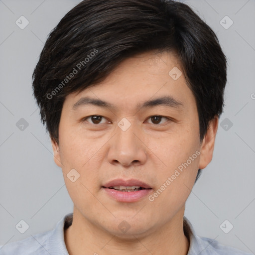 Joyful asian young-adult male with short  black hair and brown eyes