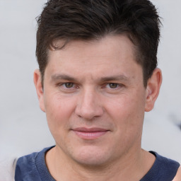 Joyful white adult male with short  brown hair and brown eyes