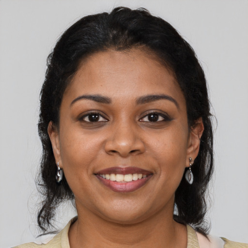 Joyful black young-adult female with medium  brown hair and brown eyes