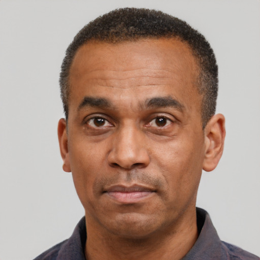 Neutral latino adult male with short  black hair and brown eyes