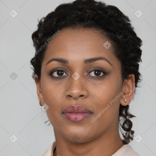 Joyful black young-adult female with short  black hair and brown eyes