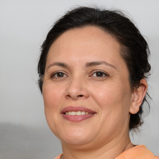 Joyful white adult female with medium  brown hair and brown eyes