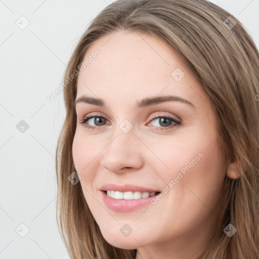 Joyful white young-adult female with long  brown hair and grey eyes