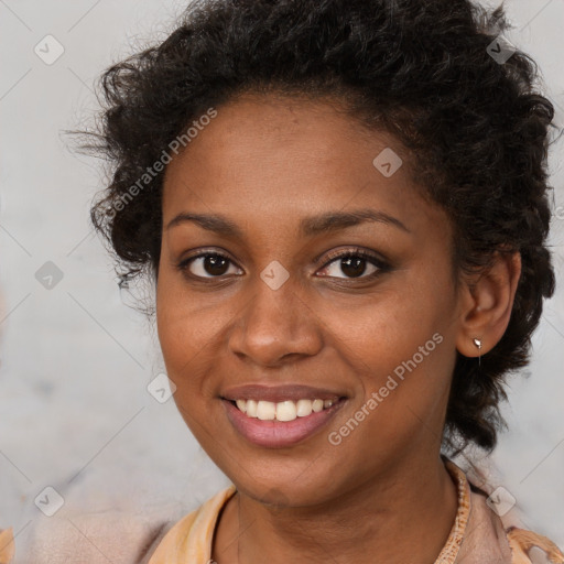 Joyful black young-adult female with short  brown hair and brown eyes