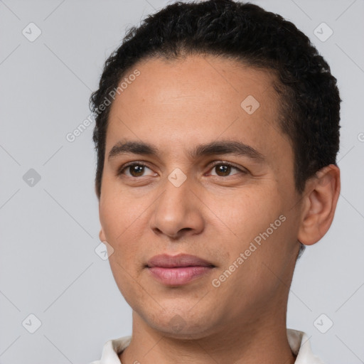 Joyful white young-adult male with short  black hair and brown eyes