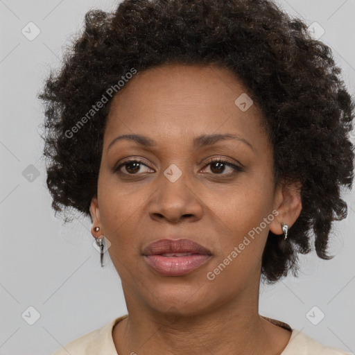 Joyful black adult female with short  brown hair and brown eyes