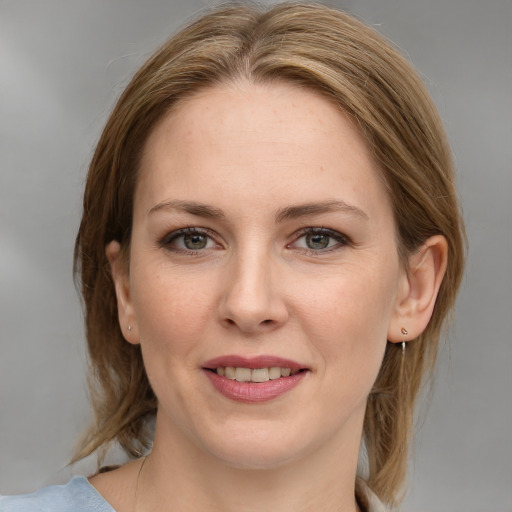 Joyful white young-adult female with medium  brown hair and blue eyes