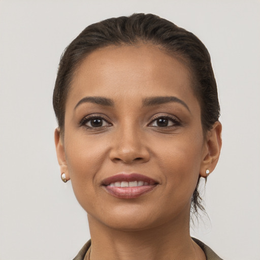 Joyful latino young-adult female with short  brown hair and brown eyes