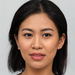 Joyful asian young-adult female with medium  brown hair and brown eyes