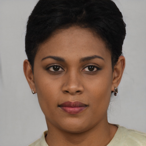 Joyful black young-adult female with short  brown hair and brown eyes