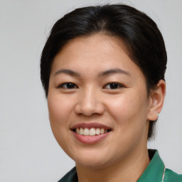 Joyful asian young-adult female with short  brown hair and brown eyes