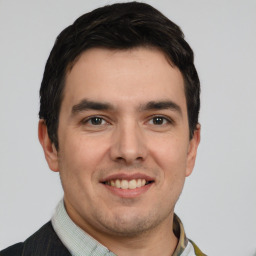 Joyful white young-adult male with short  black hair and brown eyes