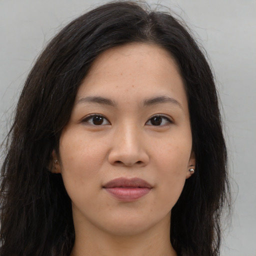 Joyful asian young-adult female with long  brown hair and brown eyes