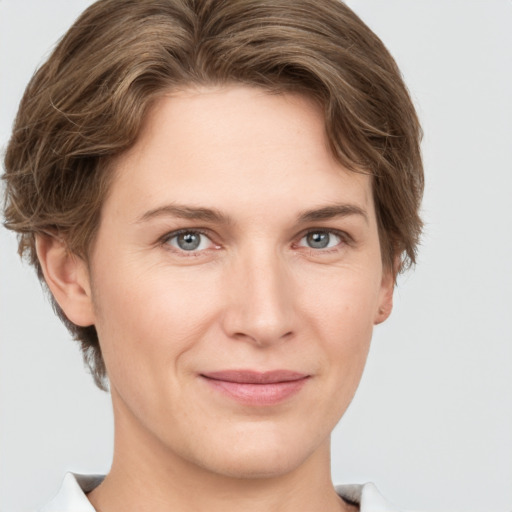 Joyful white young-adult female with short  brown hair and grey eyes