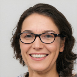 Joyful white adult female with medium  brown hair and brown eyes