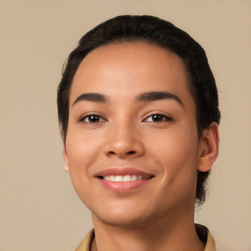 Joyful latino young-adult female with short  black hair and brown eyes