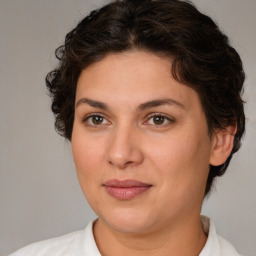 Joyful white adult female with medium  brown hair and brown eyes