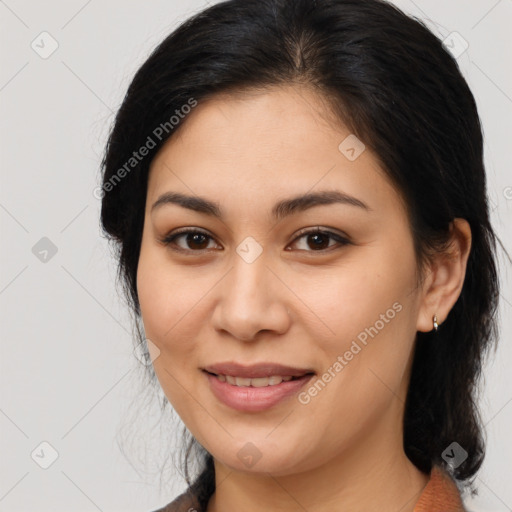 Joyful latino young-adult female with medium  brown hair and brown eyes