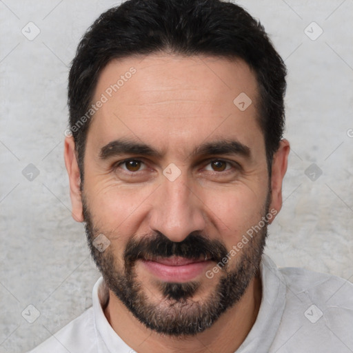 Joyful white adult male with short  black hair and brown eyes