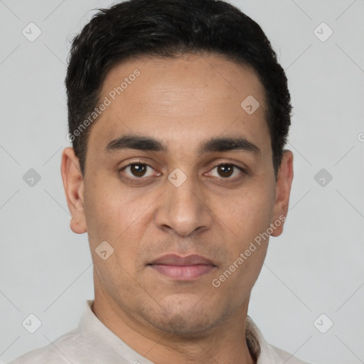 Joyful white young-adult male with short  black hair and brown eyes