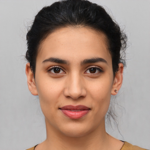 Joyful latino young-adult female with medium  brown hair and brown eyes