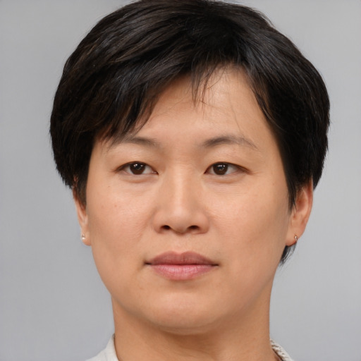 Joyful asian young-adult female with short  brown hair and brown eyes