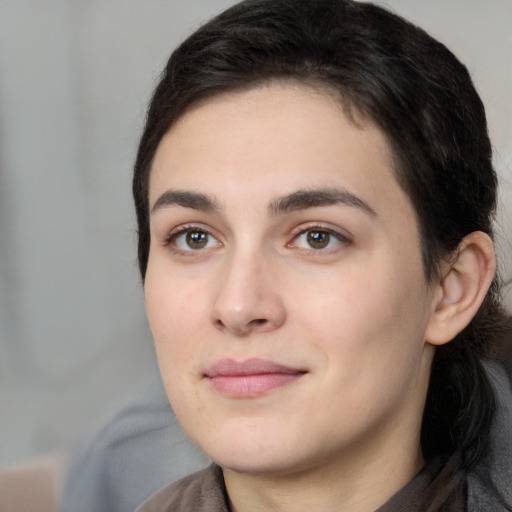 Joyful white young-adult female with medium  black hair and brown eyes