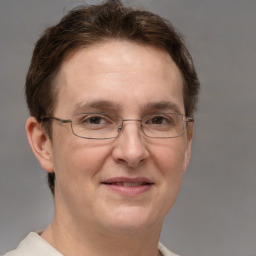 Joyful white adult female with short  brown hair and grey eyes