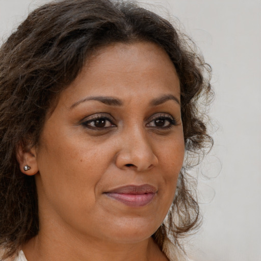 Joyful black adult female with long  brown hair and brown eyes