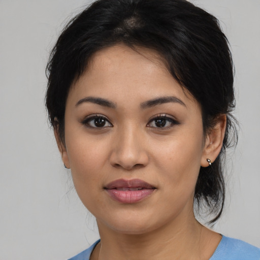 Joyful latino young-adult female with medium  black hair and brown eyes