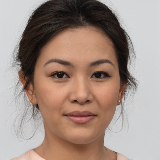 Joyful asian young-adult female with medium  brown hair and brown eyes