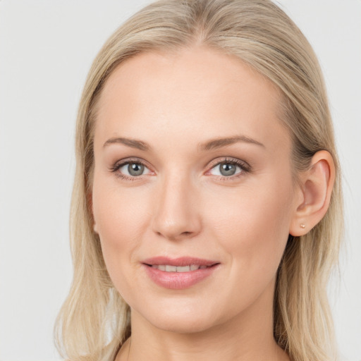 Joyful white young-adult female with long  brown hair and blue eyes